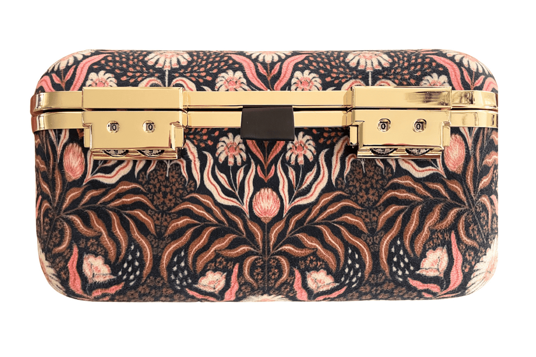 Boho nouveau stash box keeps contents secure in style with gold plated combination locks.